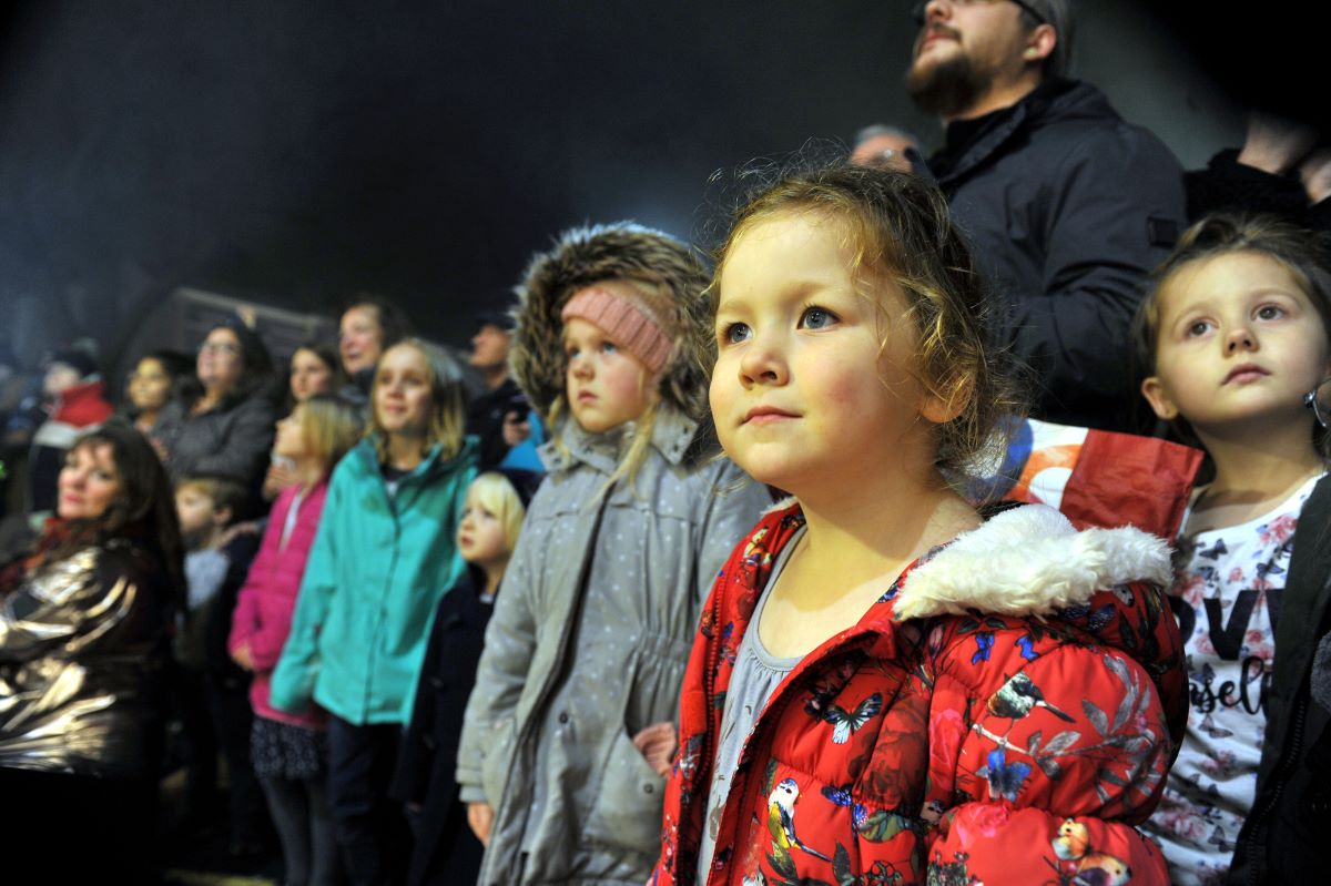 Children in crowd watching Christmas Light Switch On